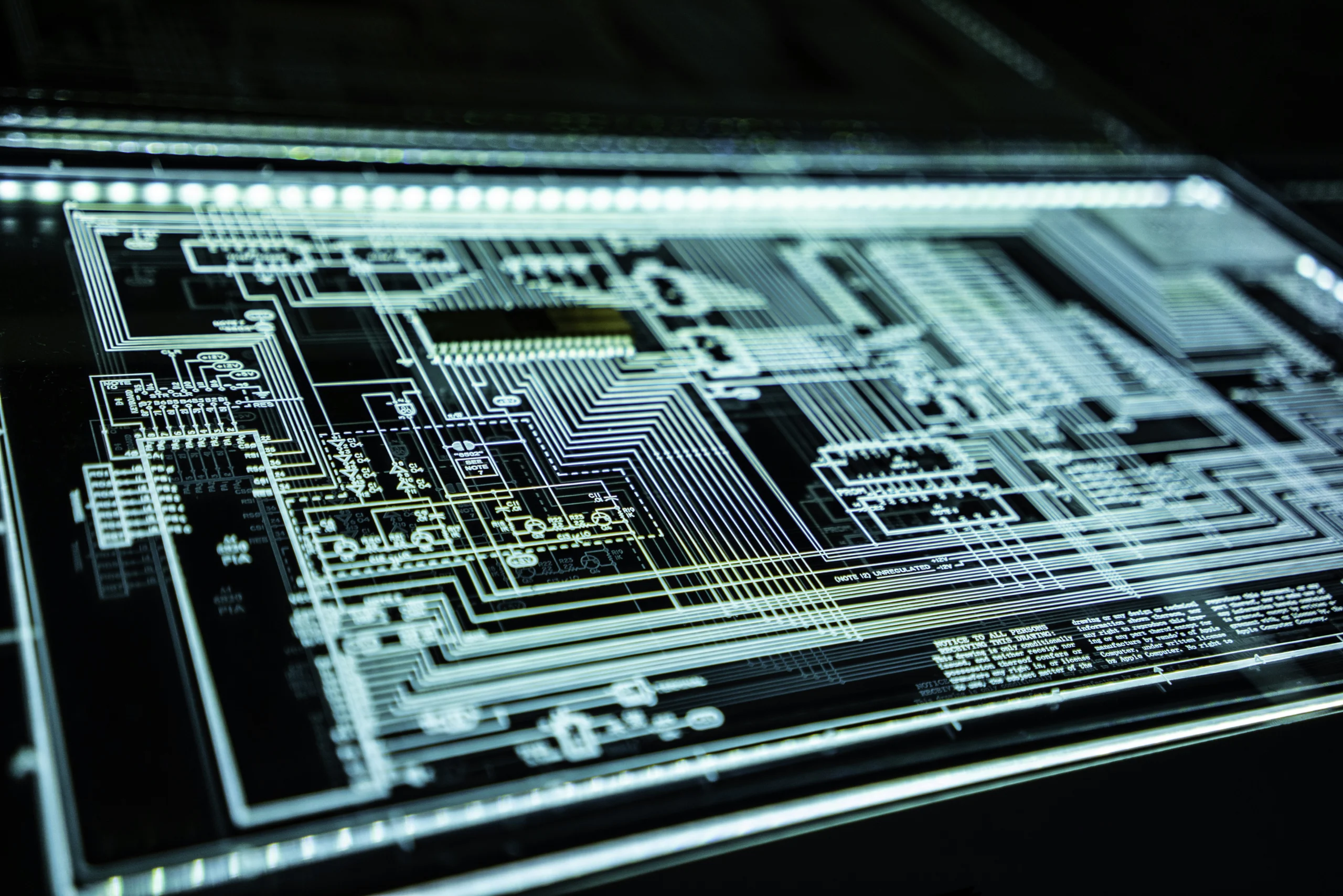 Close-up of silver high-performance computing hardware and circuit boards, representing the cognitive infrastructure of the Verification Economy.