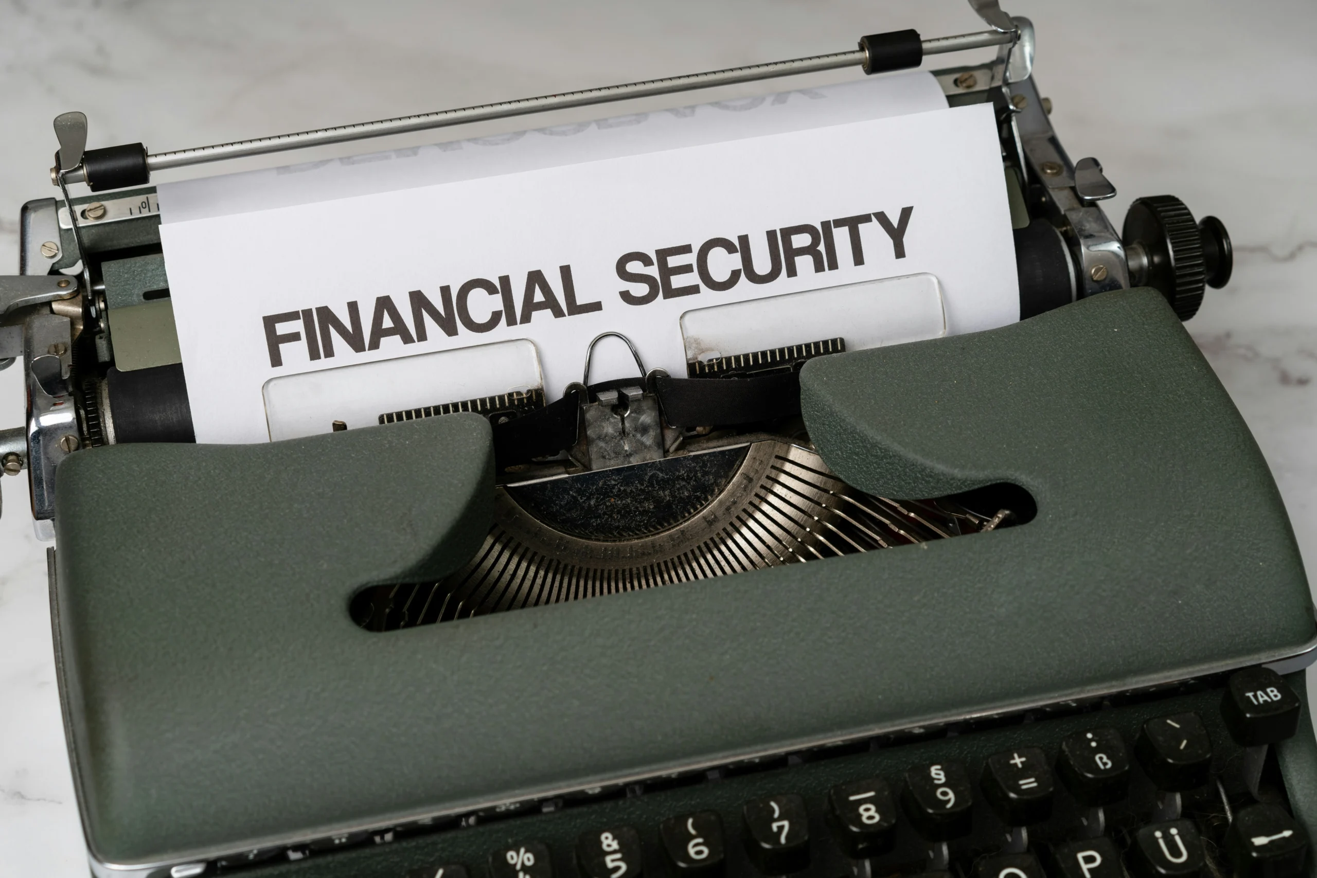 The Hard-Coded Audit — Photo by Markus Winkler (Unsplash) Close up of a vintage typewriter typing 'Financial Security', symbolizing the return to hard-coded, readable audit trails.